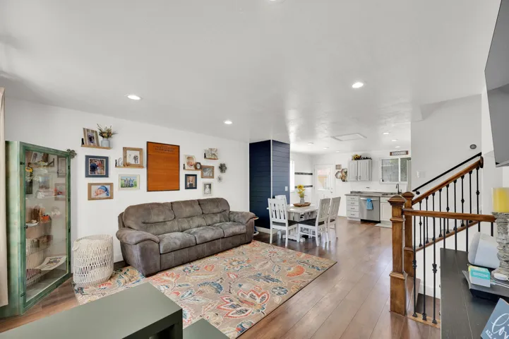 Living room with hardwood / wood-style flooring and recessed lighting