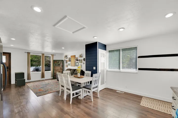 Dining space featuring dark wood-style flooring, healthy amount of natural light, and recessed lighting