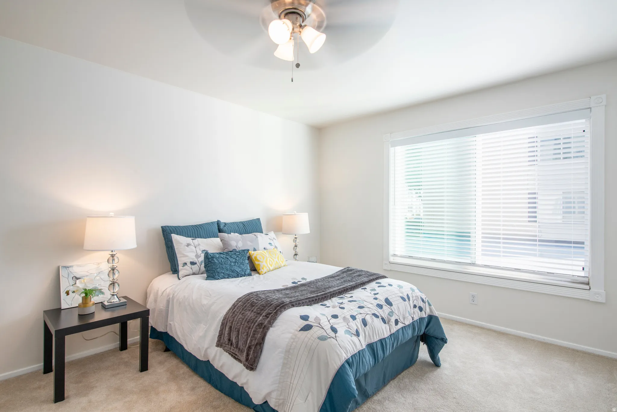 Bedroom with light carpet and ceiling fan