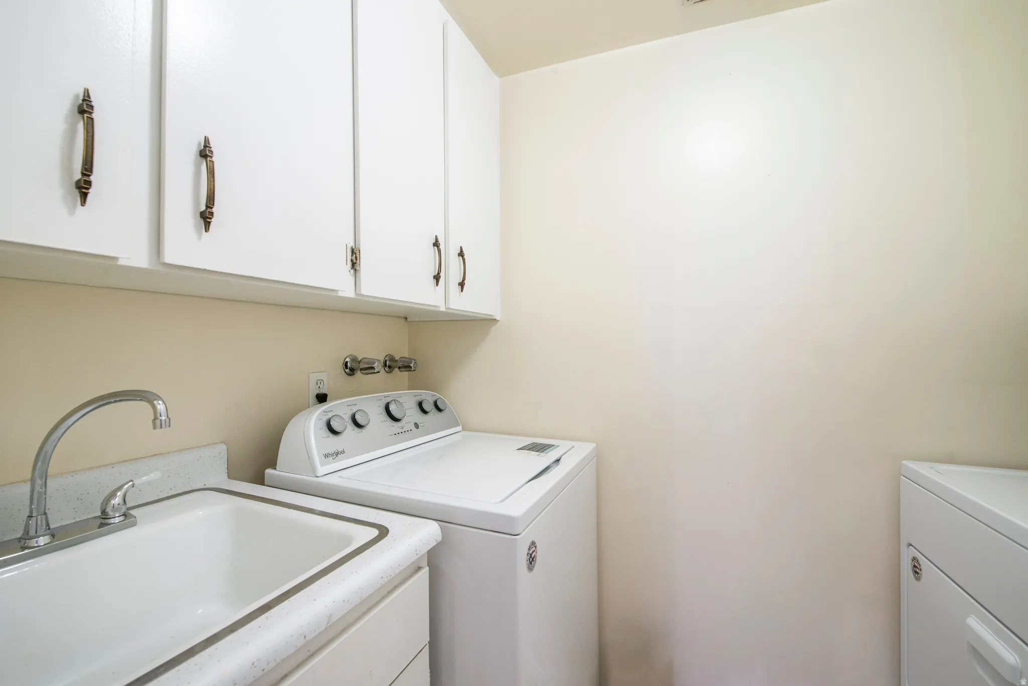 Laundry area featuring a sink and washer and clothes dryer