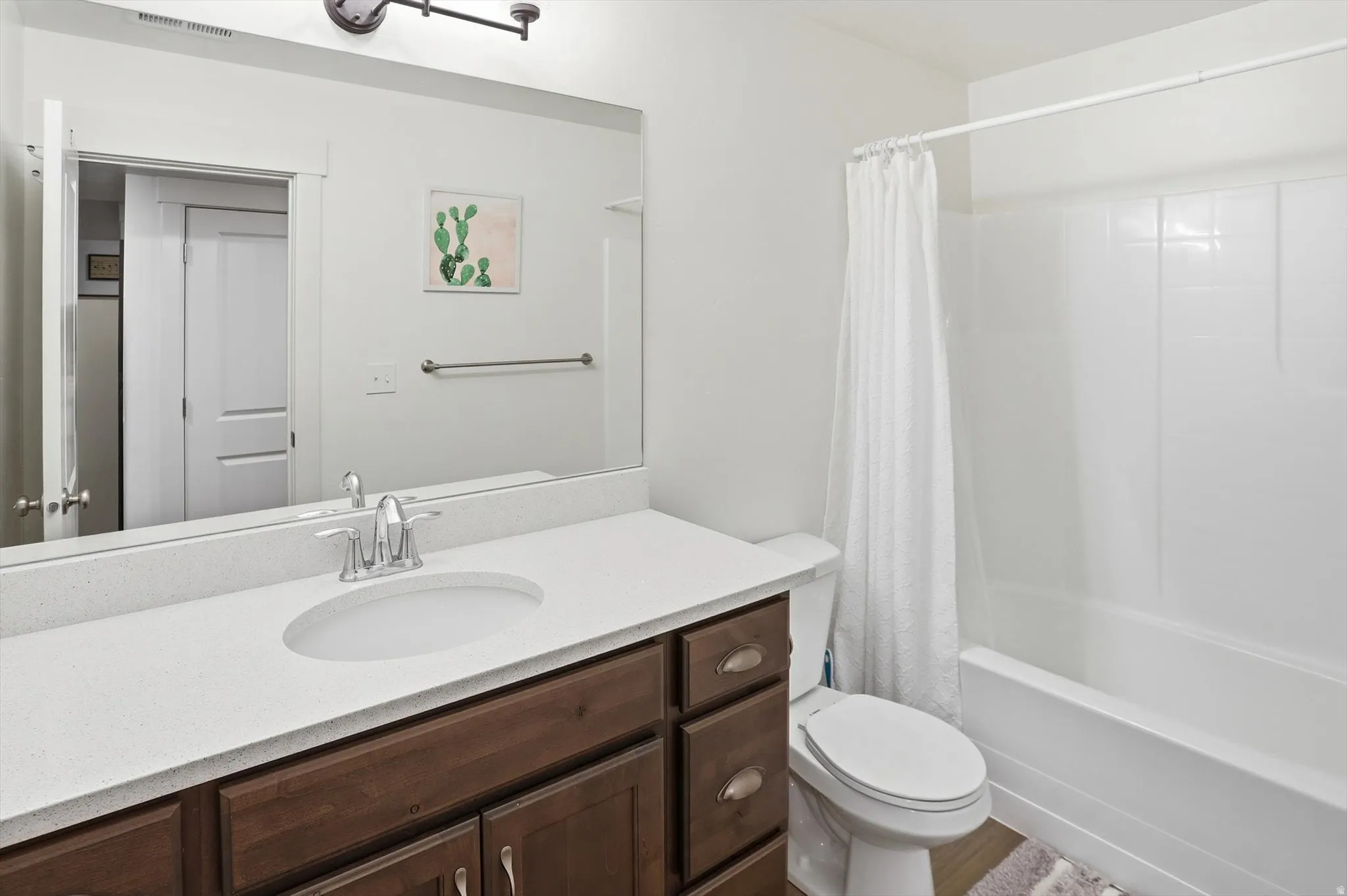 Full bath featuring vanity and shower / bath combo with shower curtain