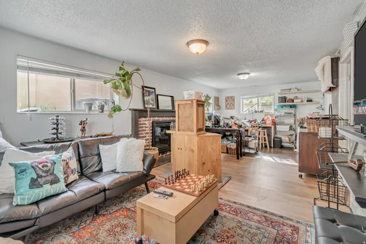 Flex space can be a large bedroom with walk in closet or as a family room, a textured ceiling, and a brick fireplace