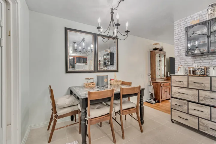 Dining area featuring hanging lights and light tile patterned flooring