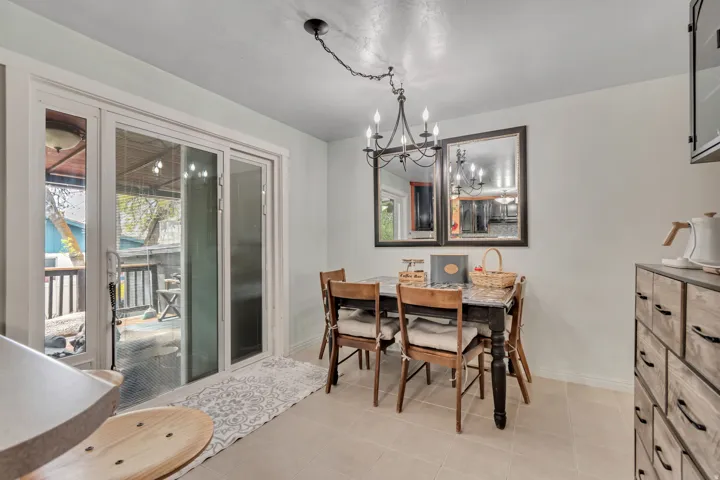 Dining room with a chandelier and light tile patterned flooring
