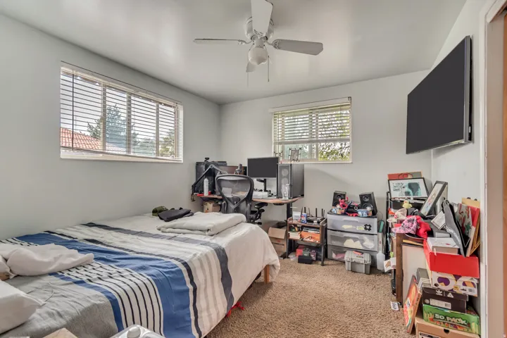 Bedroom featuring light colored carpet and a ceiling fan
