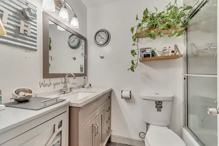 Full bath with vanity and shower / bath combination with glass door