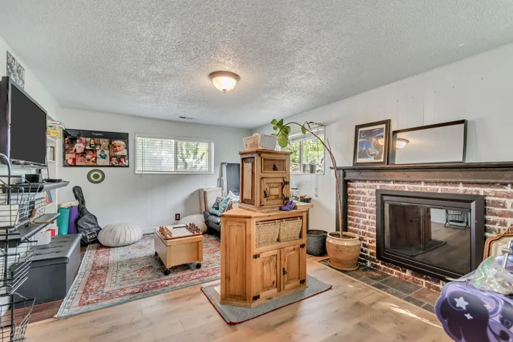 Flex space can be a large bedroom with walk in closet or as a family room, a textured ceiling, and a brick fireplace