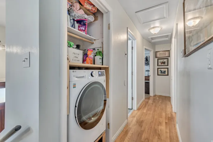 Laundry area featuring washer / dryer ventless and light wood-style flooring