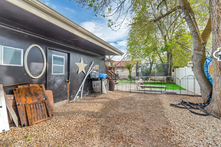 Fenced backyard with a trampoline
