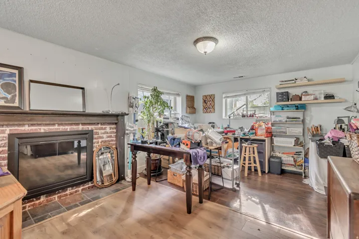 Flex space can be a large bedroom with walk in closet or as a family room, a textured ceiling, and a brick fireplace