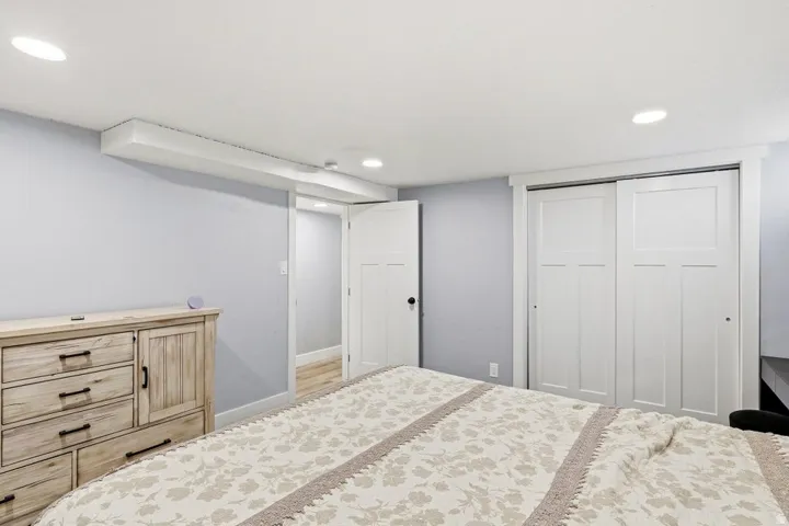 Bedroom featuring a closet, recessed lighting, and wood finished floors
