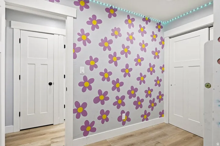 Detailed view of wood finished floors and wallpapered walls