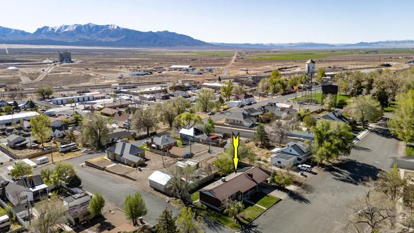 Aerial perspective of suburban area with a mountainous background