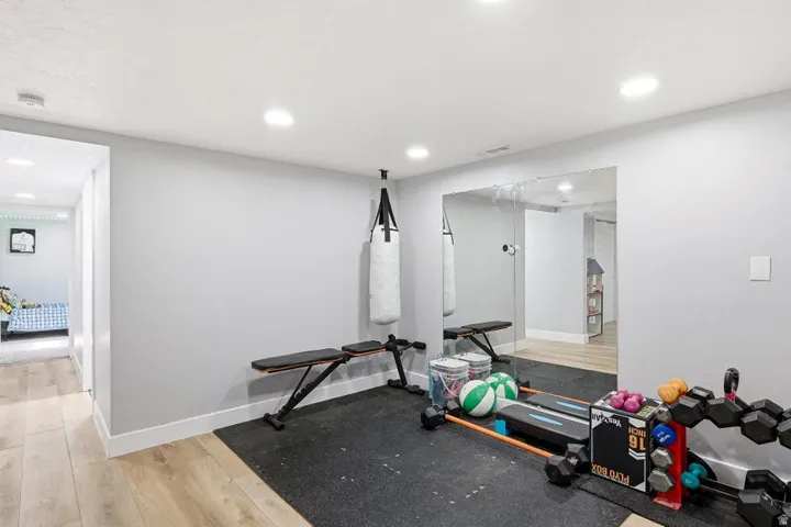 Exercise area featuring light wood-style flooring and recessed lighting