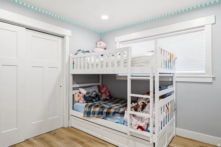 Bedroom featuring light wood-type flooring and a closet