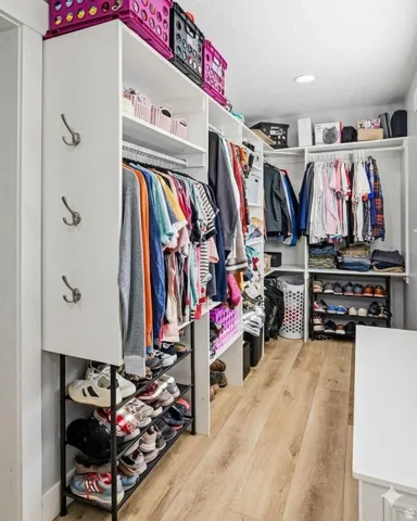 Walk in closet featuring light wood-style flooring