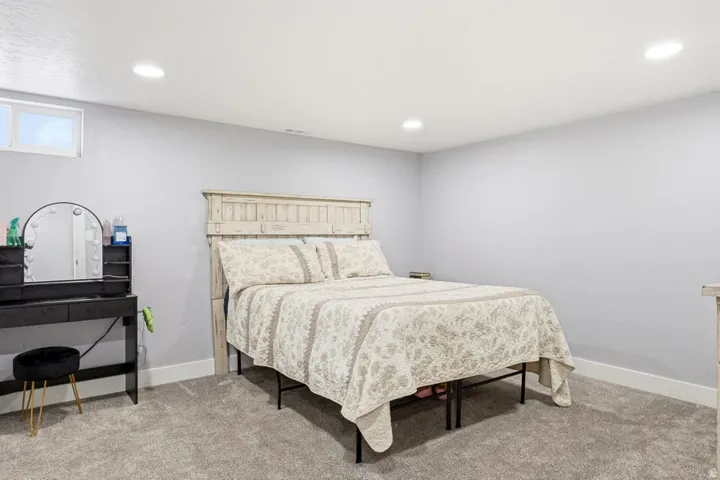 Bedroom featuring light colored carpet and recessed lighting
