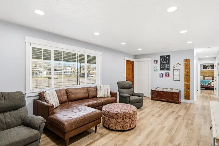 Living area featuring light wood-style floors and recessed lighting