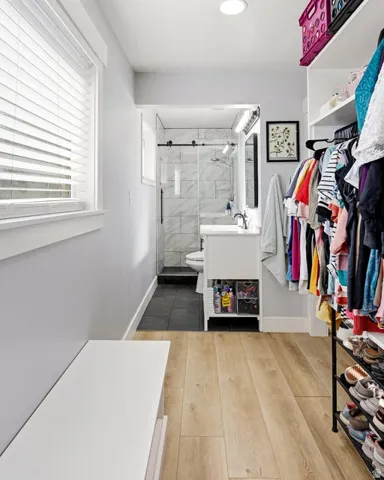 Full bath with vanity, a shower stall, and dark wood finished floors