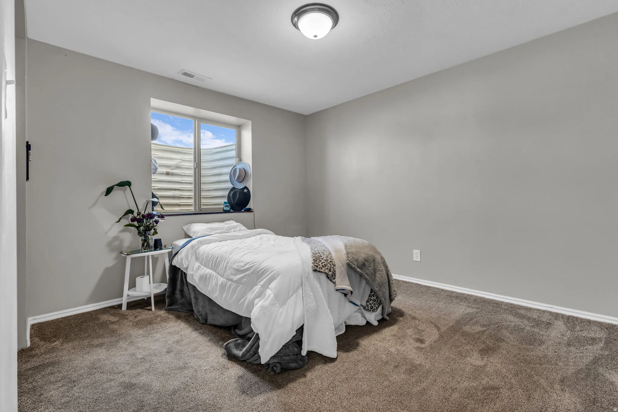 Carpeted bedroom with baseboards