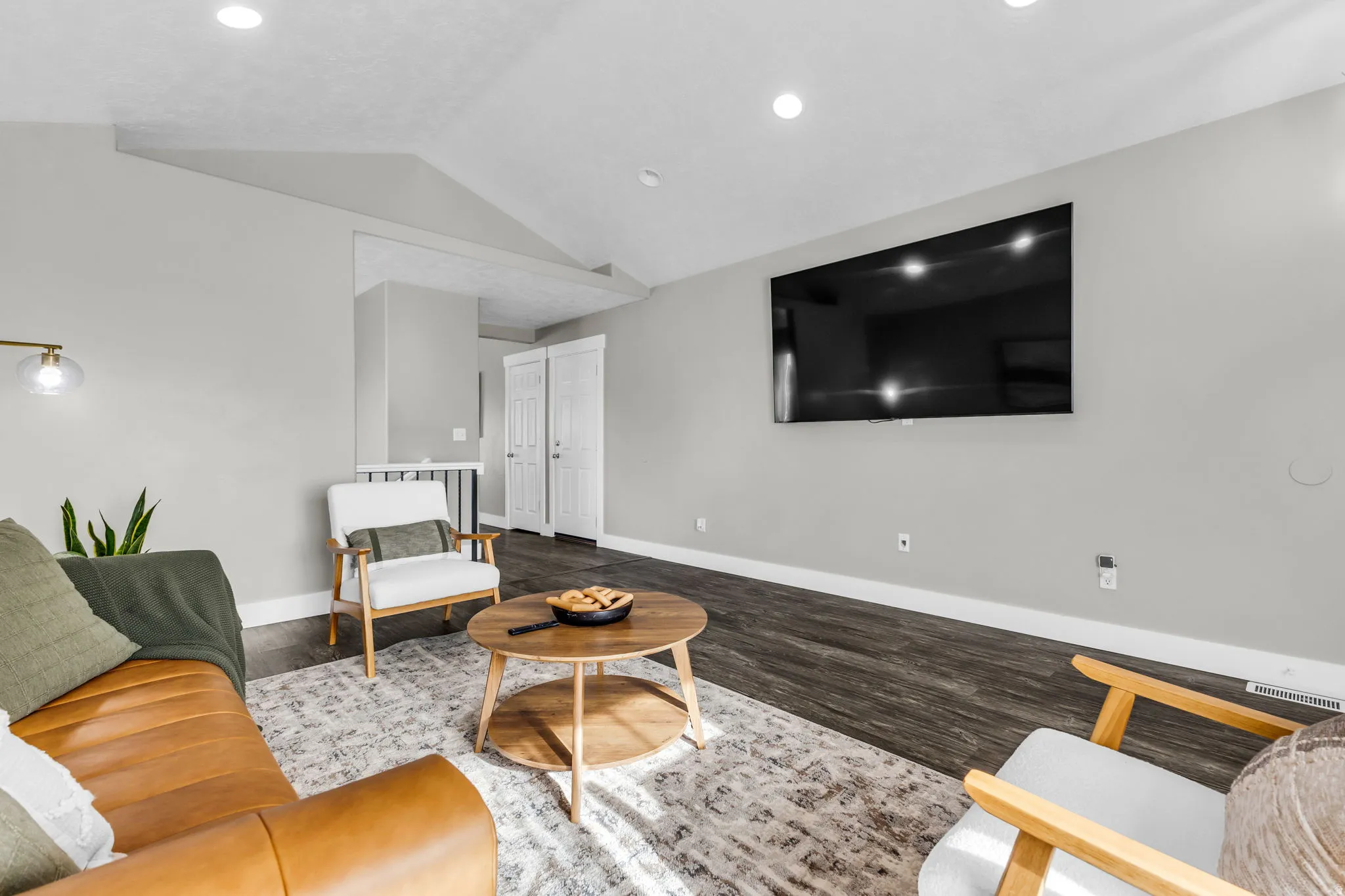 Living area featuring vaulted ceiling and wood finished floors