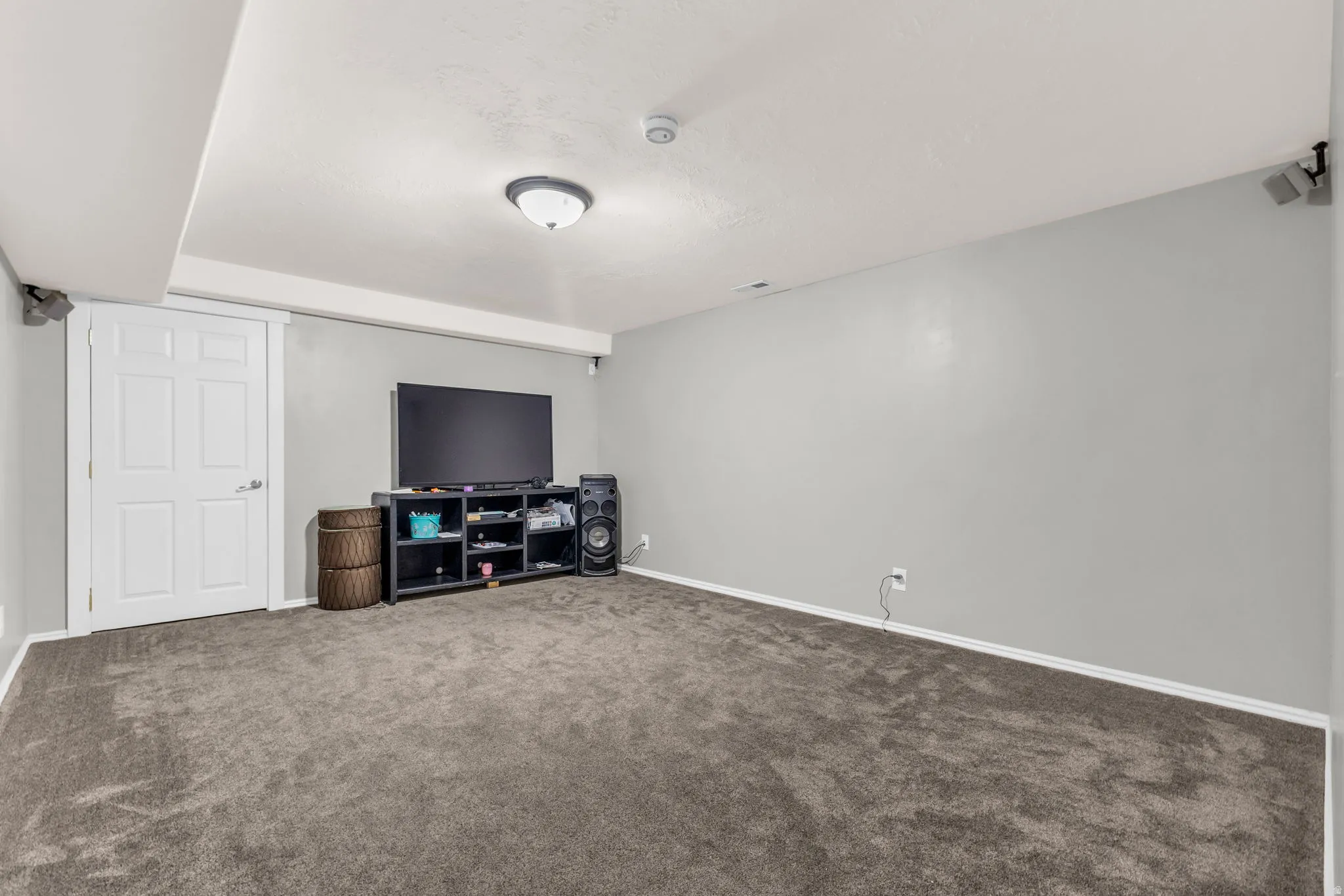 Living room featuring baseboards and dark colored carpet