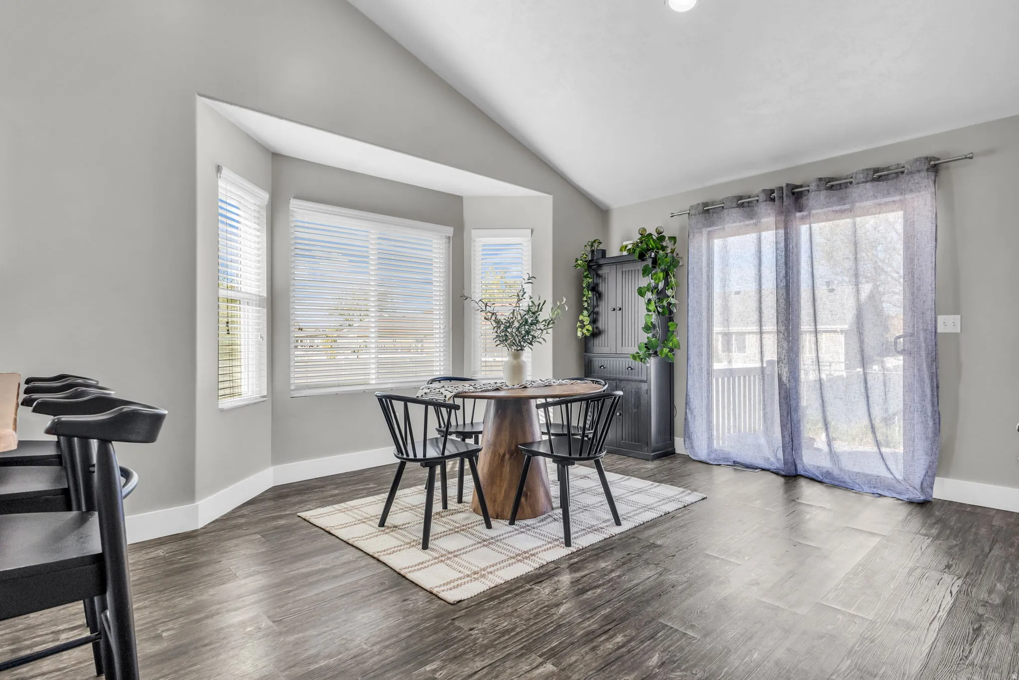 Dining area featuring vaulted ceiling and wood finished floors
