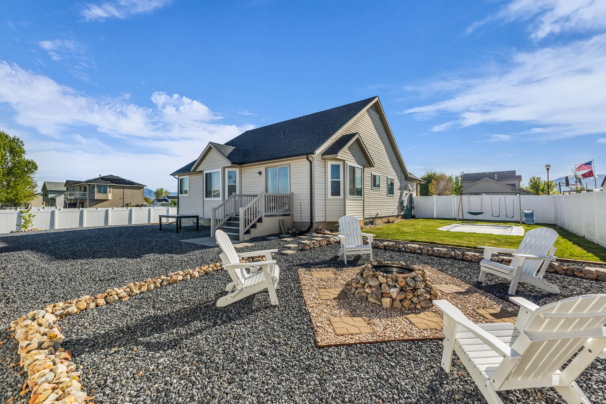 Rear view of house with a patio area, an outdoor fire pit, a fenced backyard, and roof with shingles