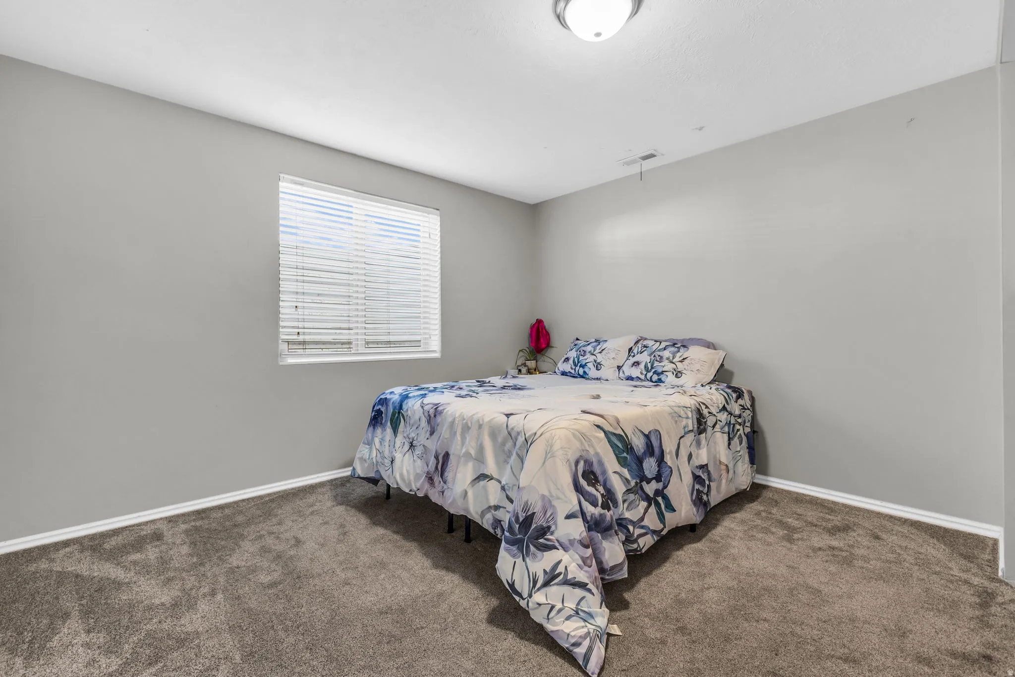 Bedroom featuring dark colored carpet and baseboards