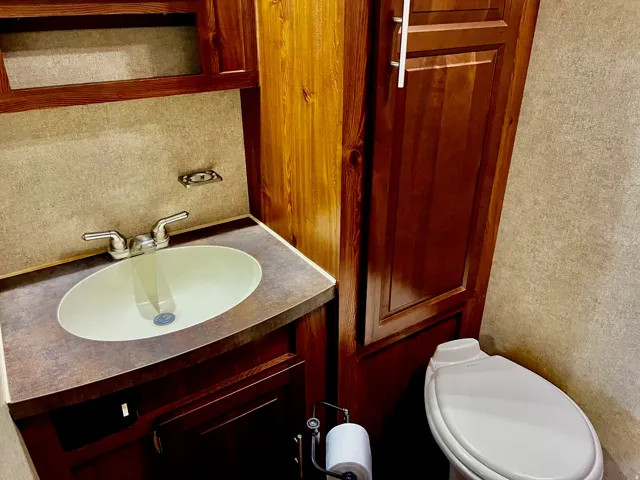 Half bathroom featuring vanity and a textured wall