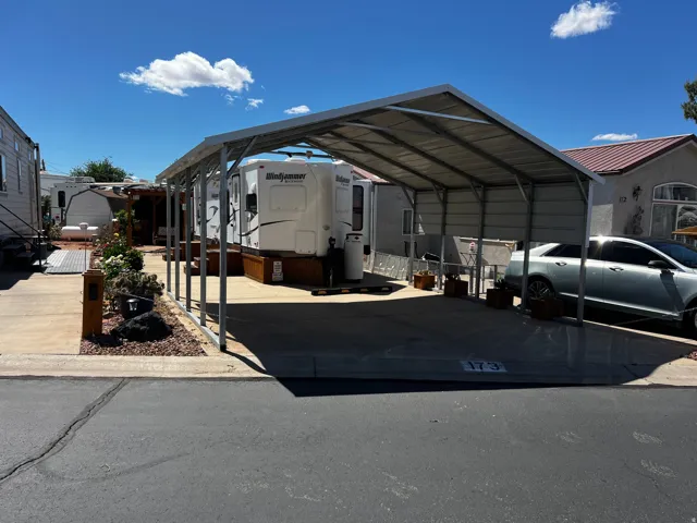 View of parking featuring a carport