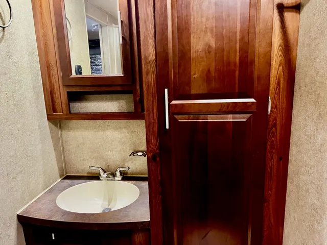 Bathroom featuring vanity and a textured wall