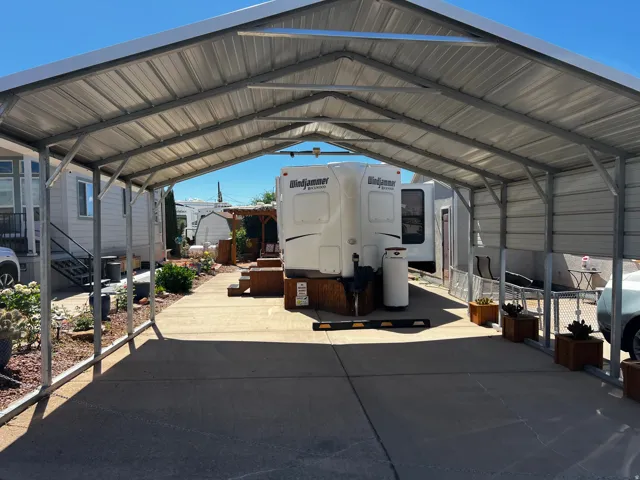 View of parking featuring a carport