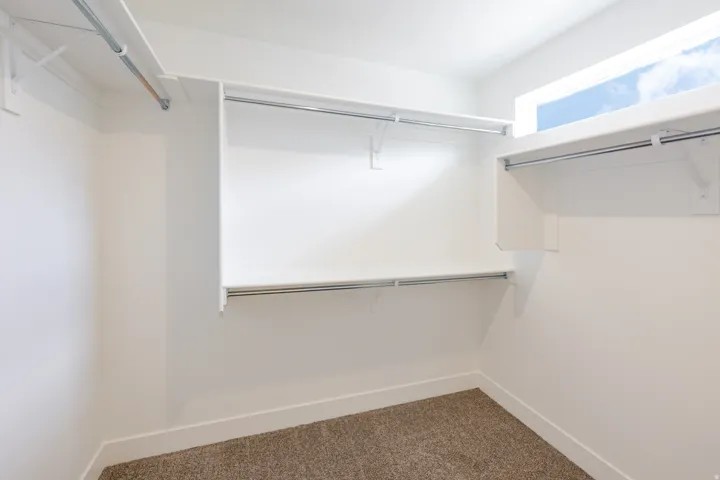 Walk-in closet with integrated shelving and hanging rods