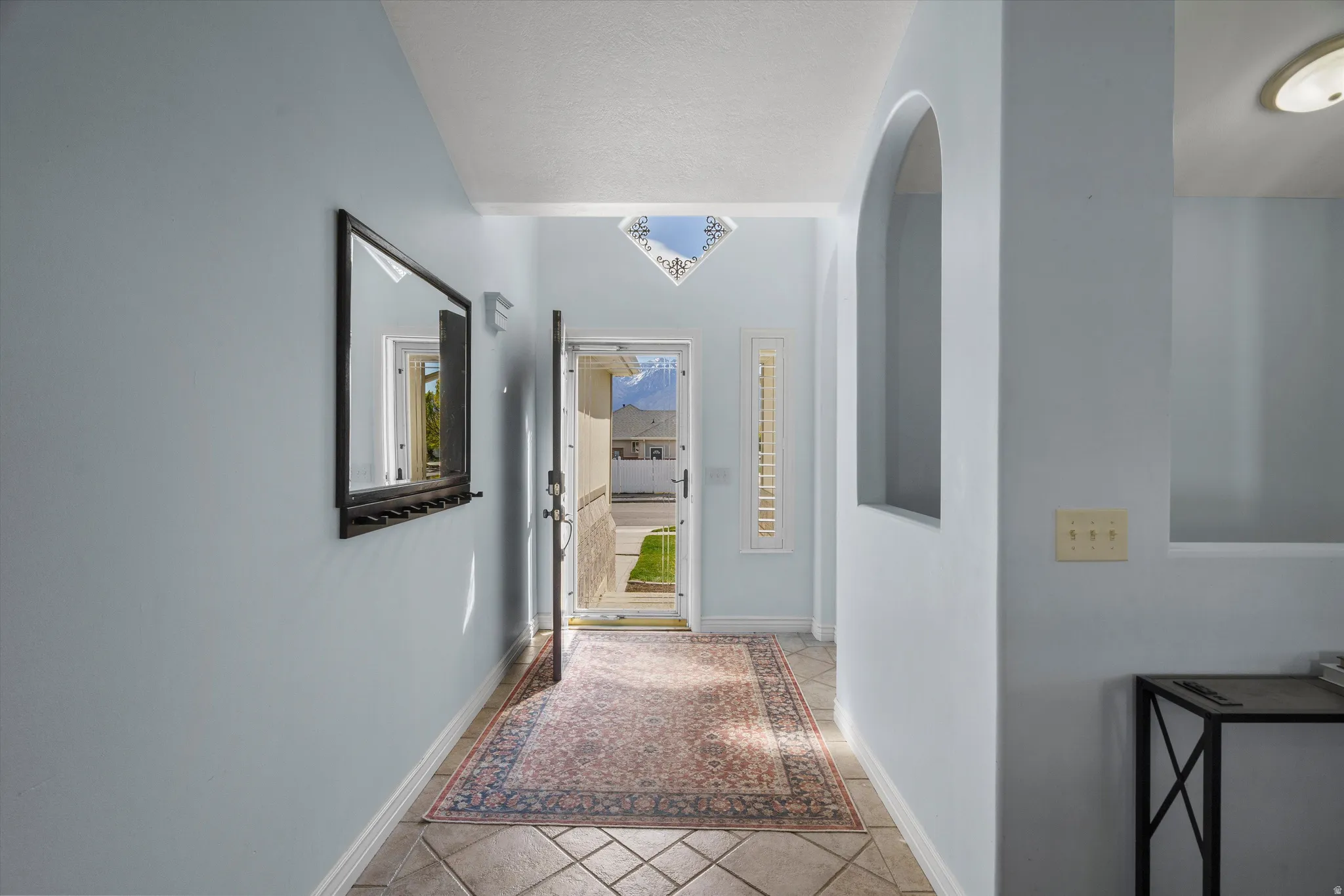 Foyer with arches and natural light.