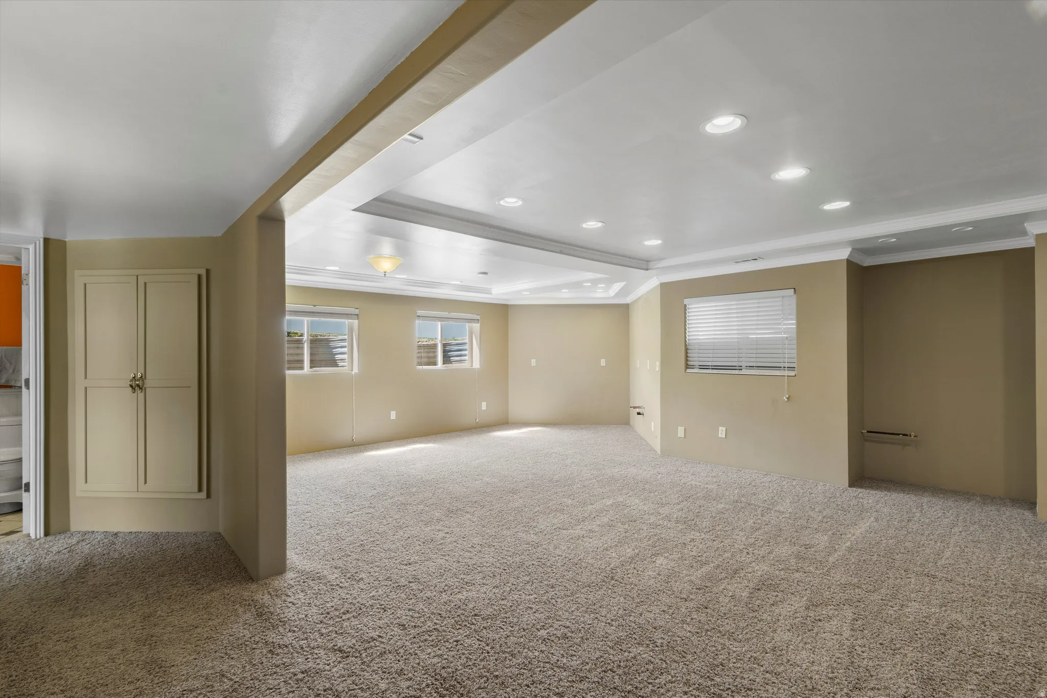 Spacious room ready to make yours. Plumbed with both culinary water and gas - this is the easiest basement kitchen enhancement you'll find complete with recessed ceiling lighting, a tray ceiling with a central fixture, multiple windows with blinds.