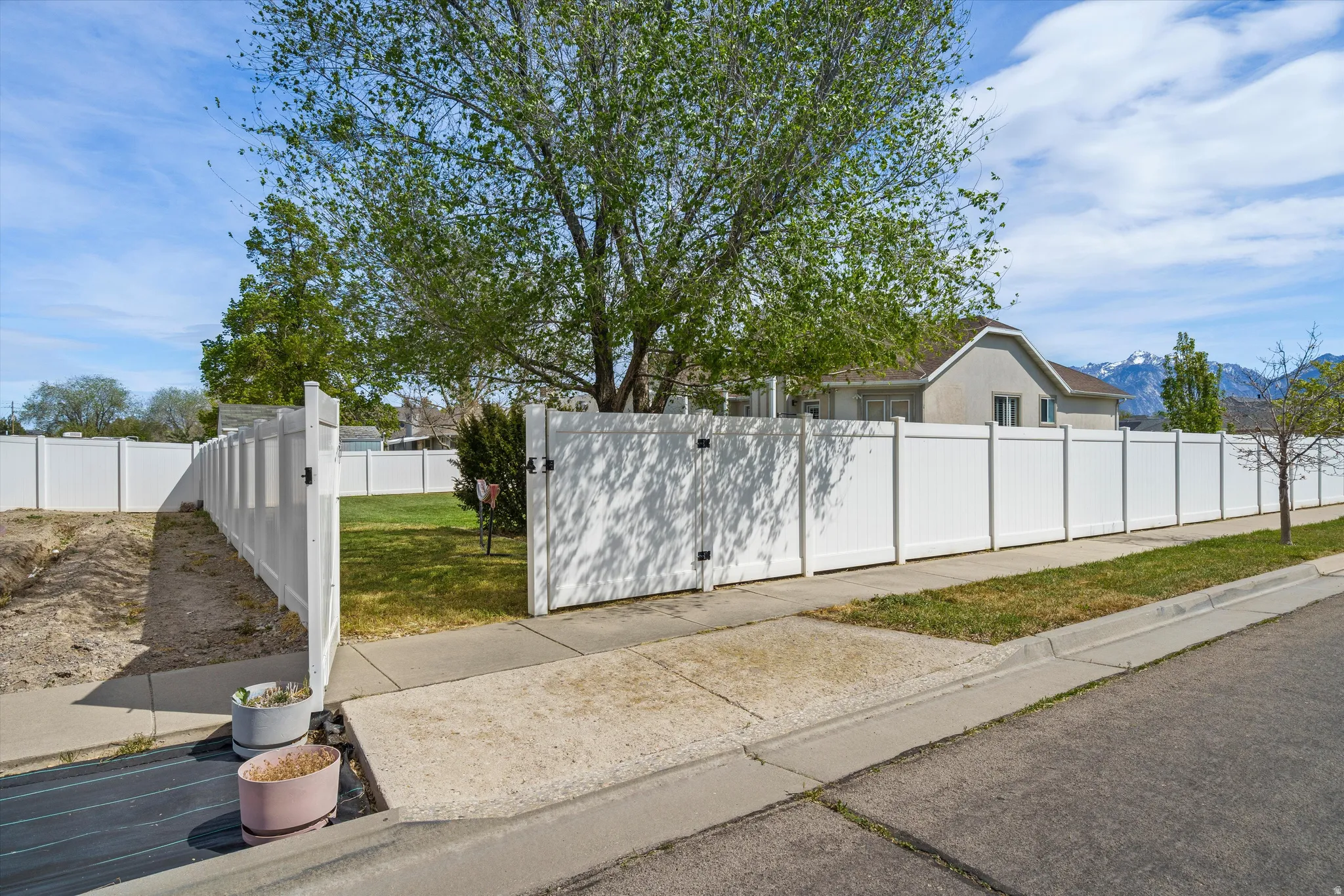 View of home's exterior with a mountain view and trailer/vehicle access point.