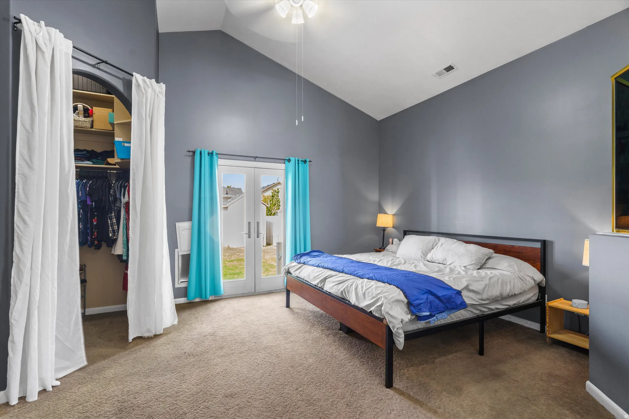 Bedroom featuring french doors, vaulted ceiling, carpet flooring, access to outside, and ceiling fan