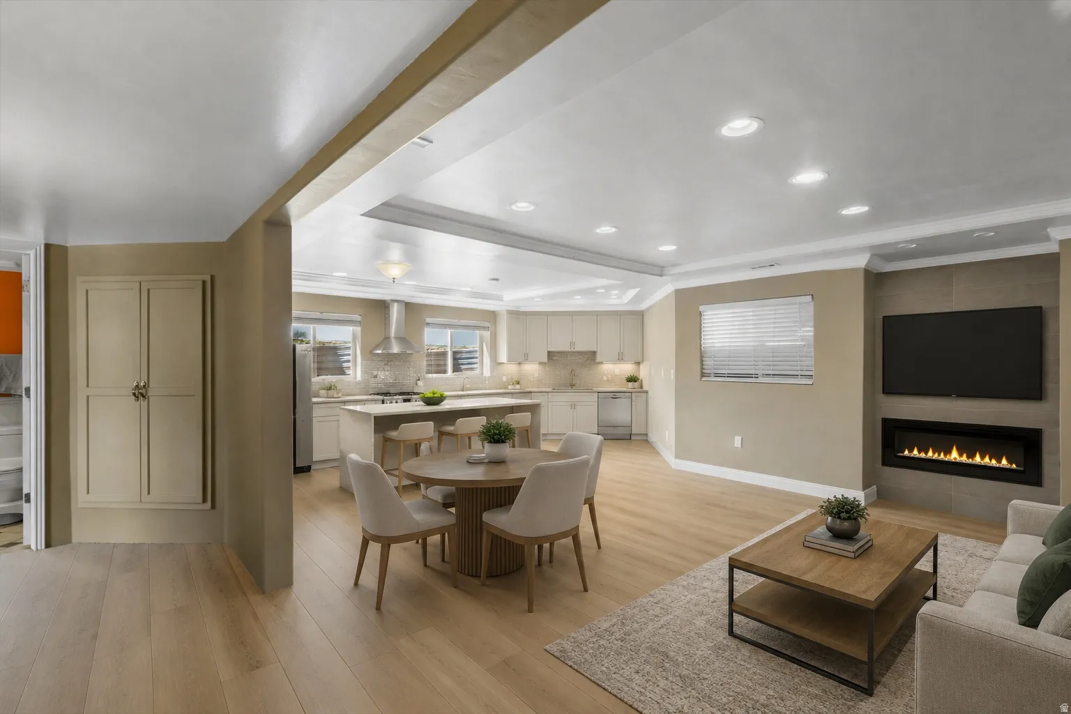 Sketch #2 of basement with open concept living space featuring wood-finish flooring, recessed lighting, and a linear fireplace. Virtually designed and staged.