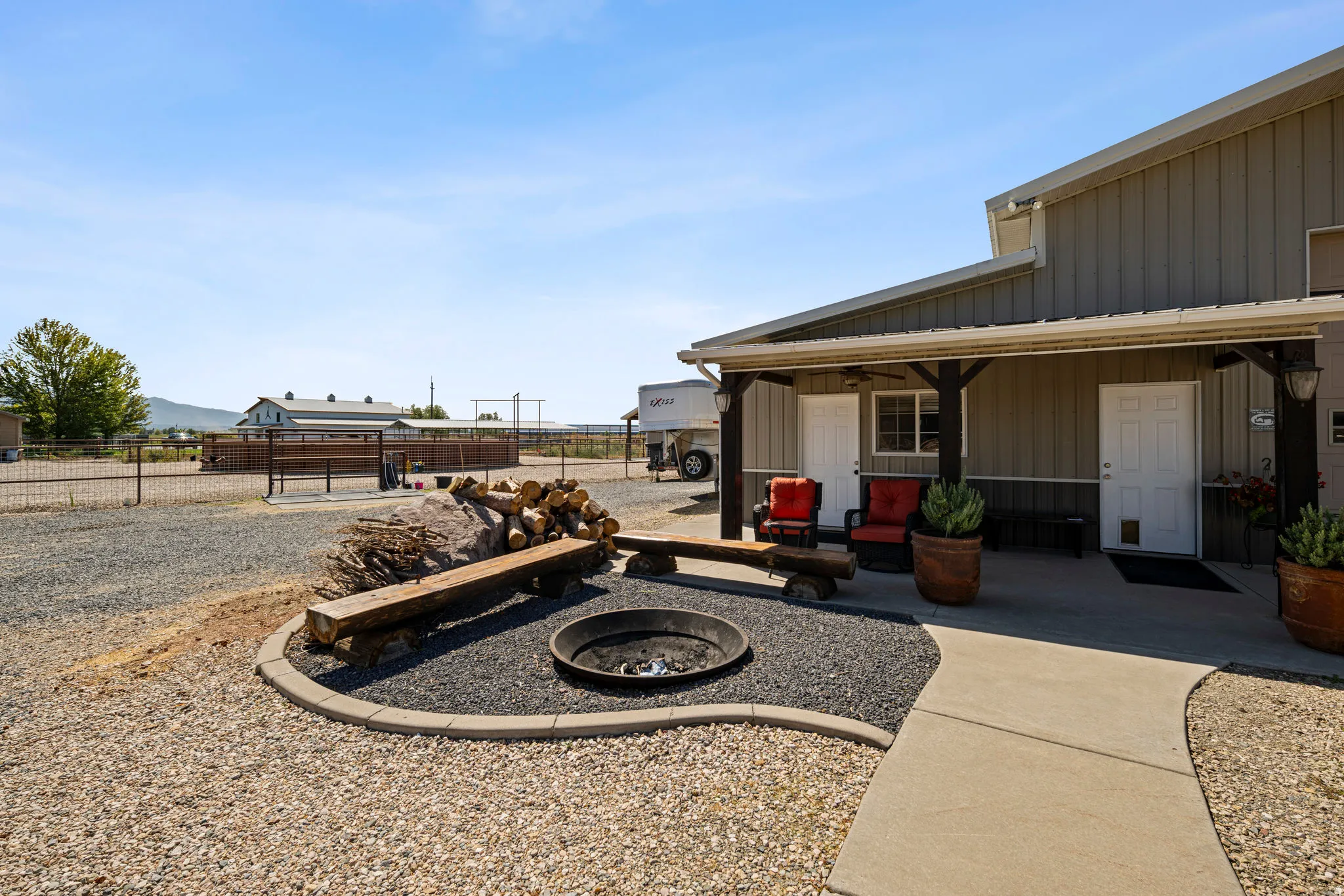 View of yard featuring an outdoor fire pit and covered porch