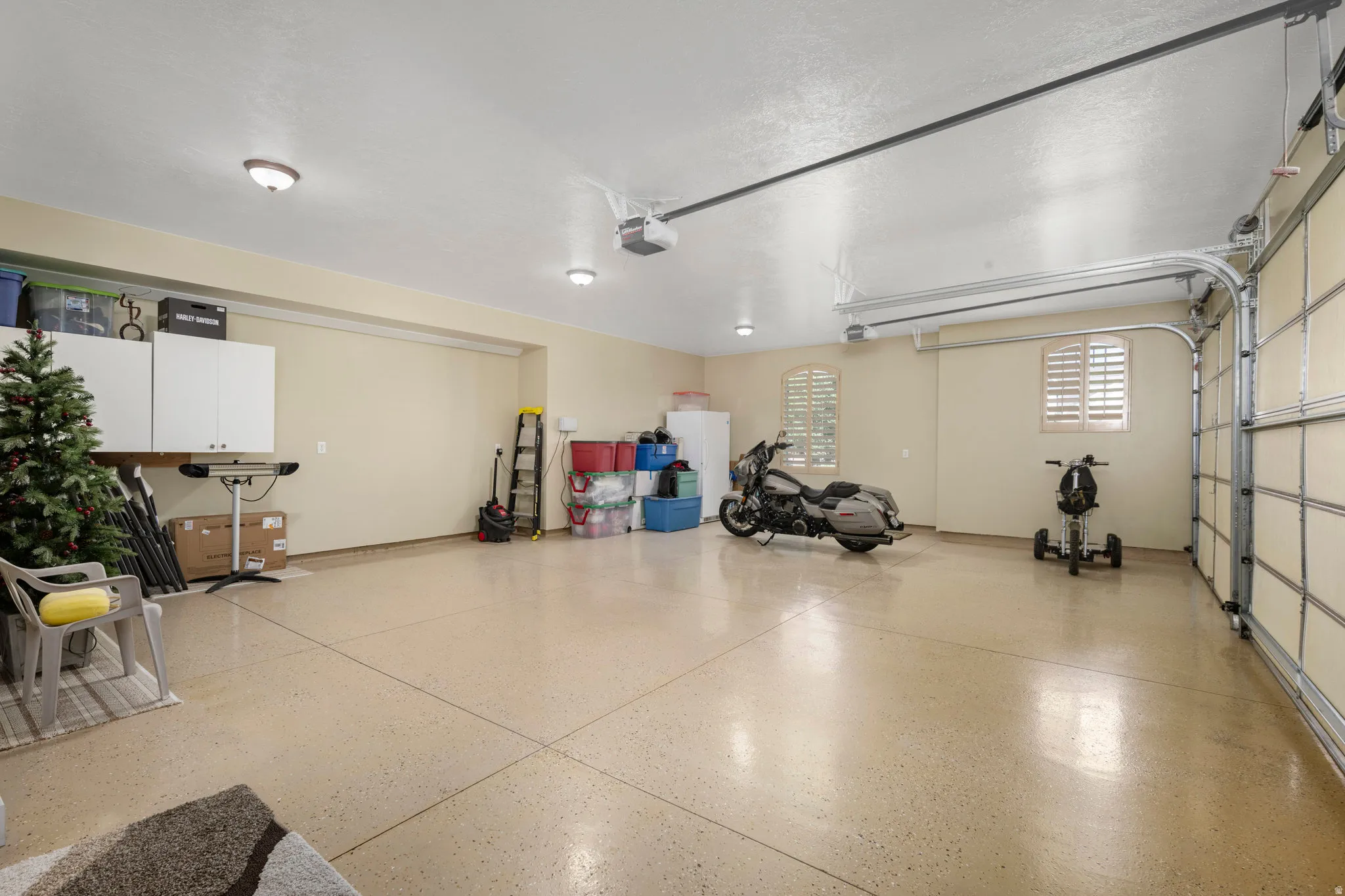 Garage featuring freestanding refrigerator