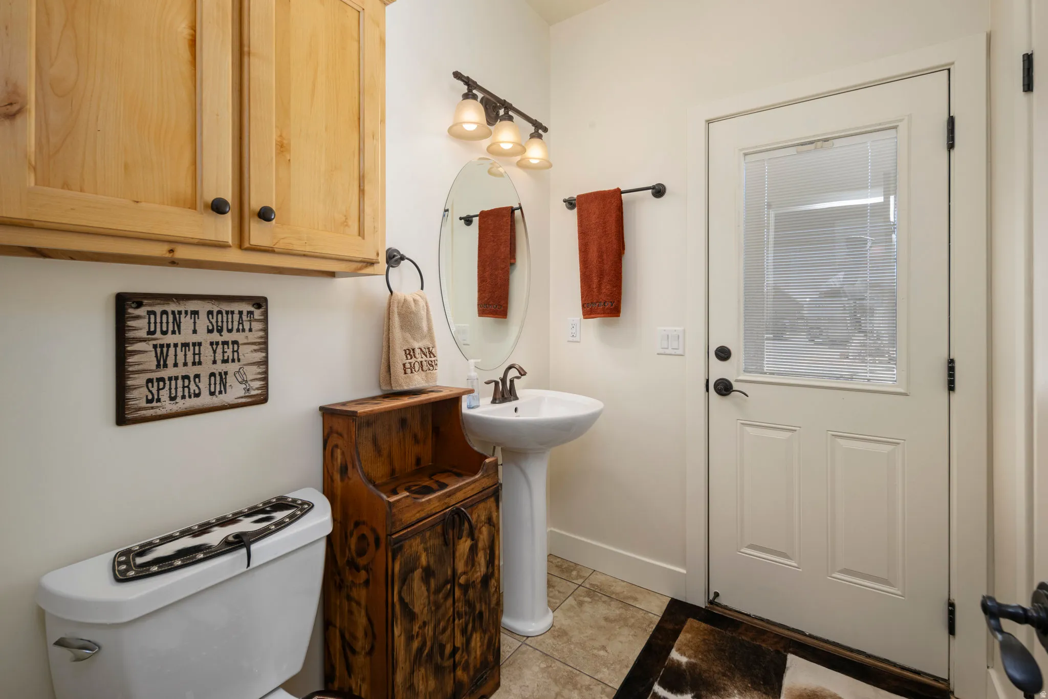 Bathroom featuring toilet and light tile patterned floors