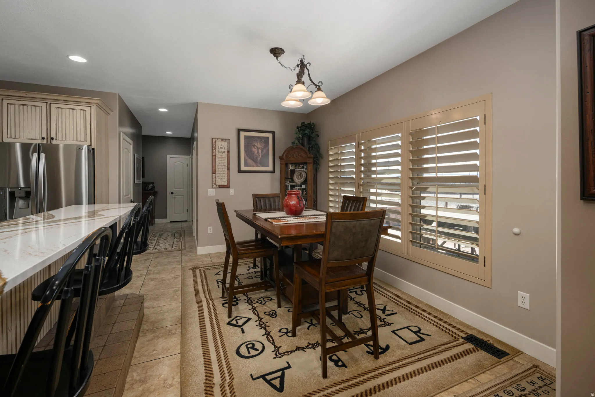 Dining room with a chandelier and light tile patterned floors