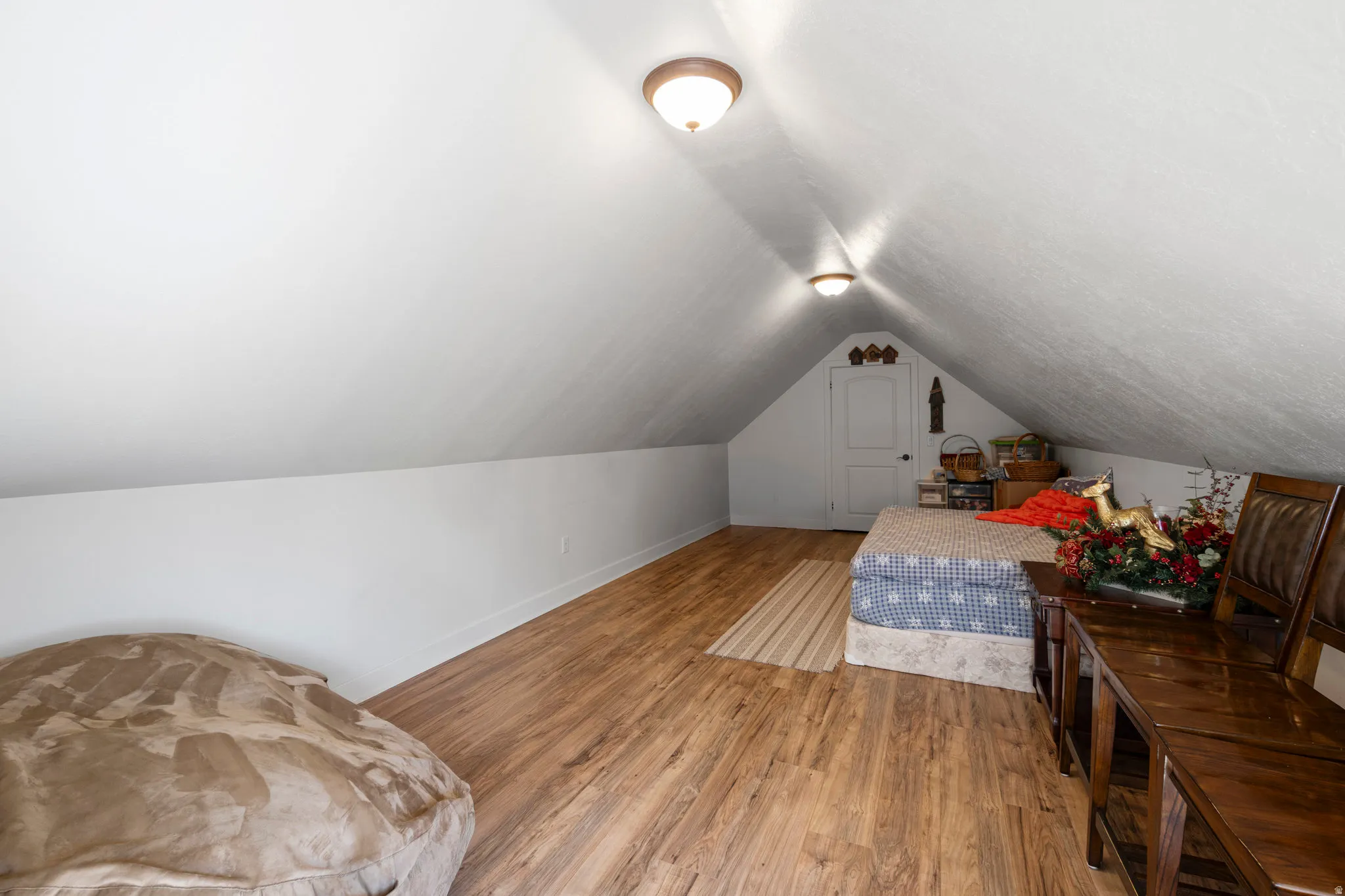 Bedroom featuring wood finished floors and baseboards