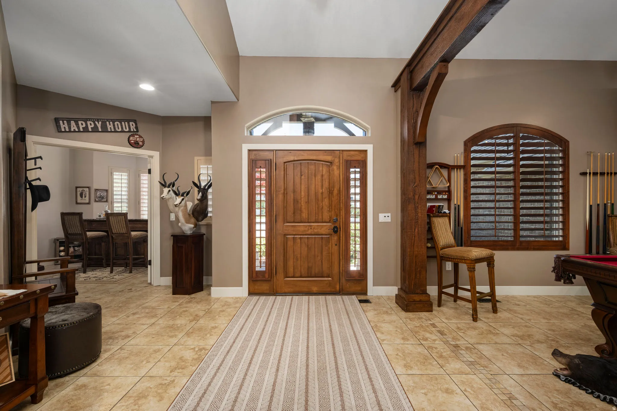 Entrance foyer with light tile patterned floors, plenty of natural light, and billiards table