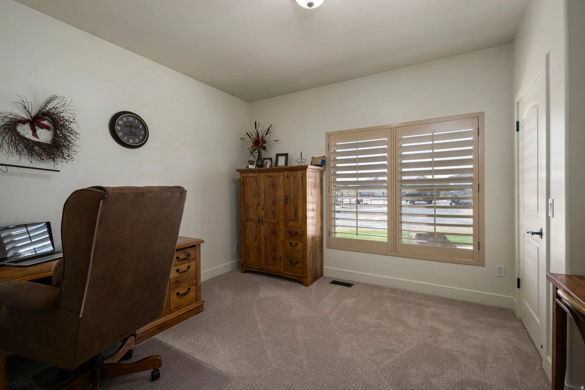 Home office with carpet floors and baseboards