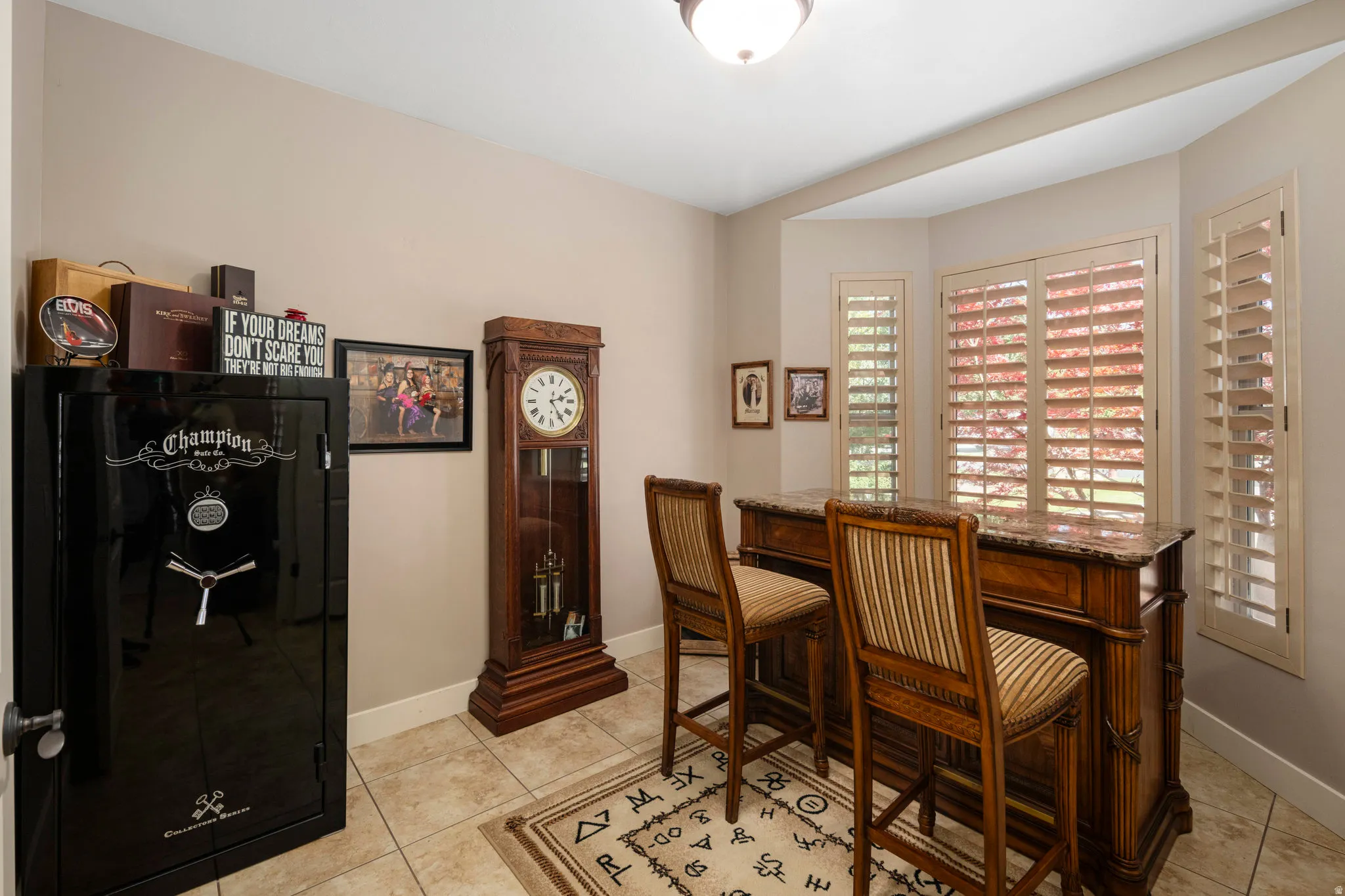 Home office with light tile patterned floors and baseboards