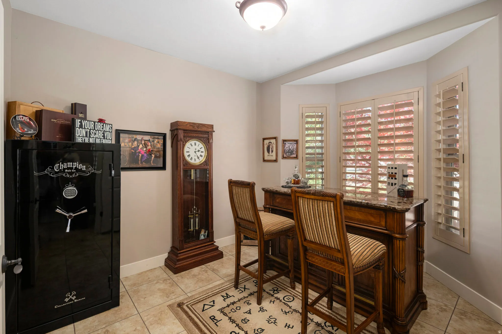 Office space featuring light tile patterned flooring and baseboards