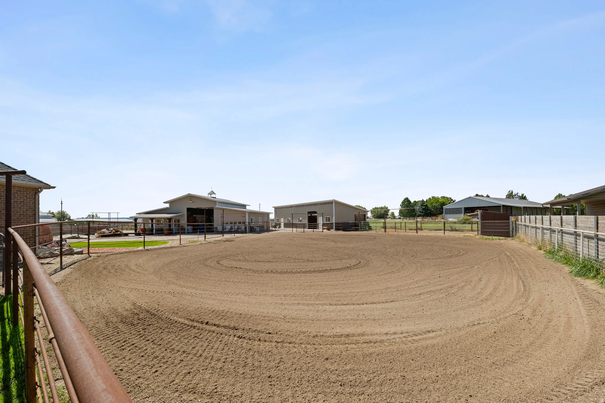 View of yard featuring an enclosed horse arena, an outbuilding, and an exterior structure
