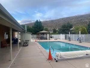 Community pool featuring a patio area and a gazebo